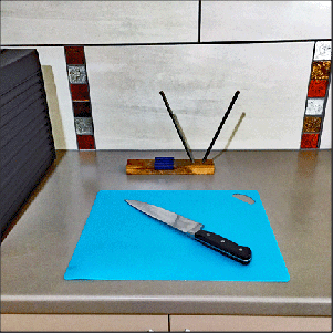 Cutting board, chef's knife, and knife sharpener.